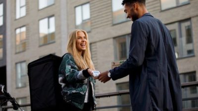 man using Visa card on stage with woman