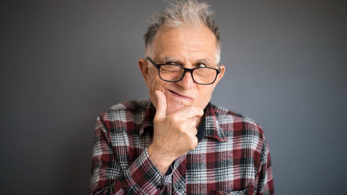 person thinking by holding hand to chin in consideration