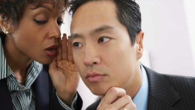 two business people sharing a secret