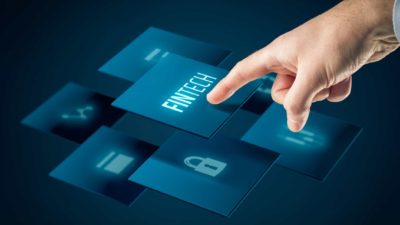 Hand pushing the display of Fintech program