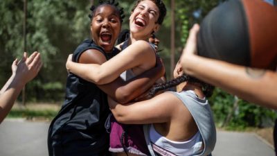 Teens having fun on the basketball court.