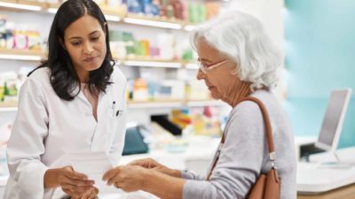 Woman serving customer in pharmacy