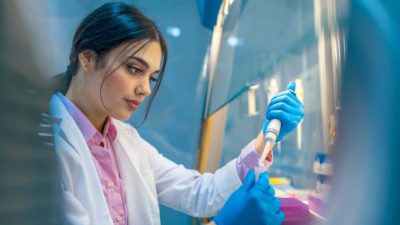 Female scientist working in laboratory for Race Oncology