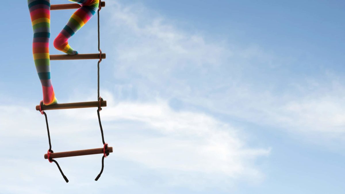 legs in colourful tights climbing a ladder into the sky