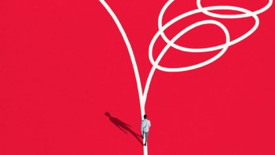 man walking down a white line about to split into two