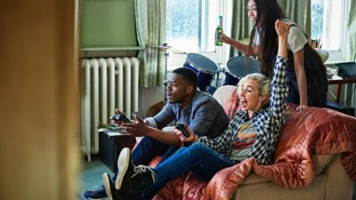 teenagers playing gamestop video game