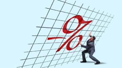 Federal Reserve ASX shares investor holding up a chart under the weight of interest rates.