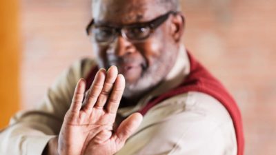 trading halt, stop, person holding up hand to indicate stop