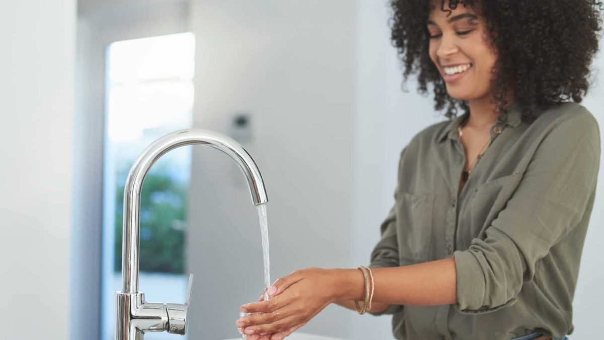 plumbing supplies, water flow, hand washing, person holds hands under flowing tap