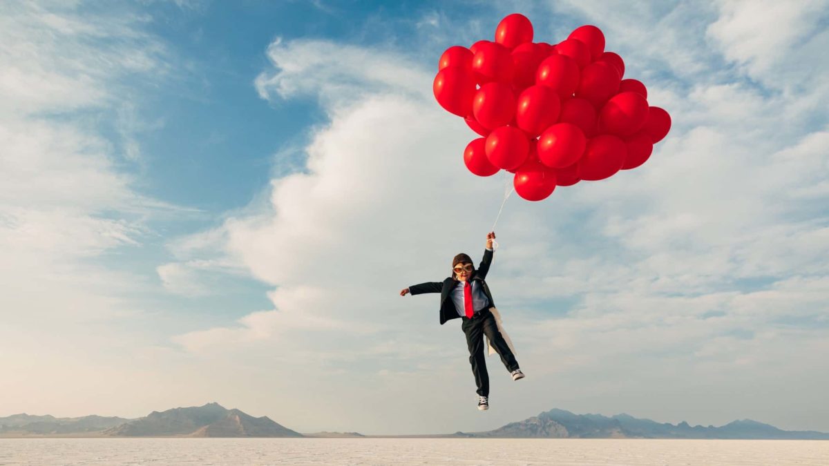 share price up, share price gain, lift, boy flying lifted by balloons