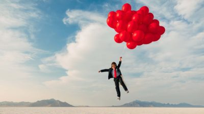 share price up, share price gain, lift, boy flying lifted by balloons