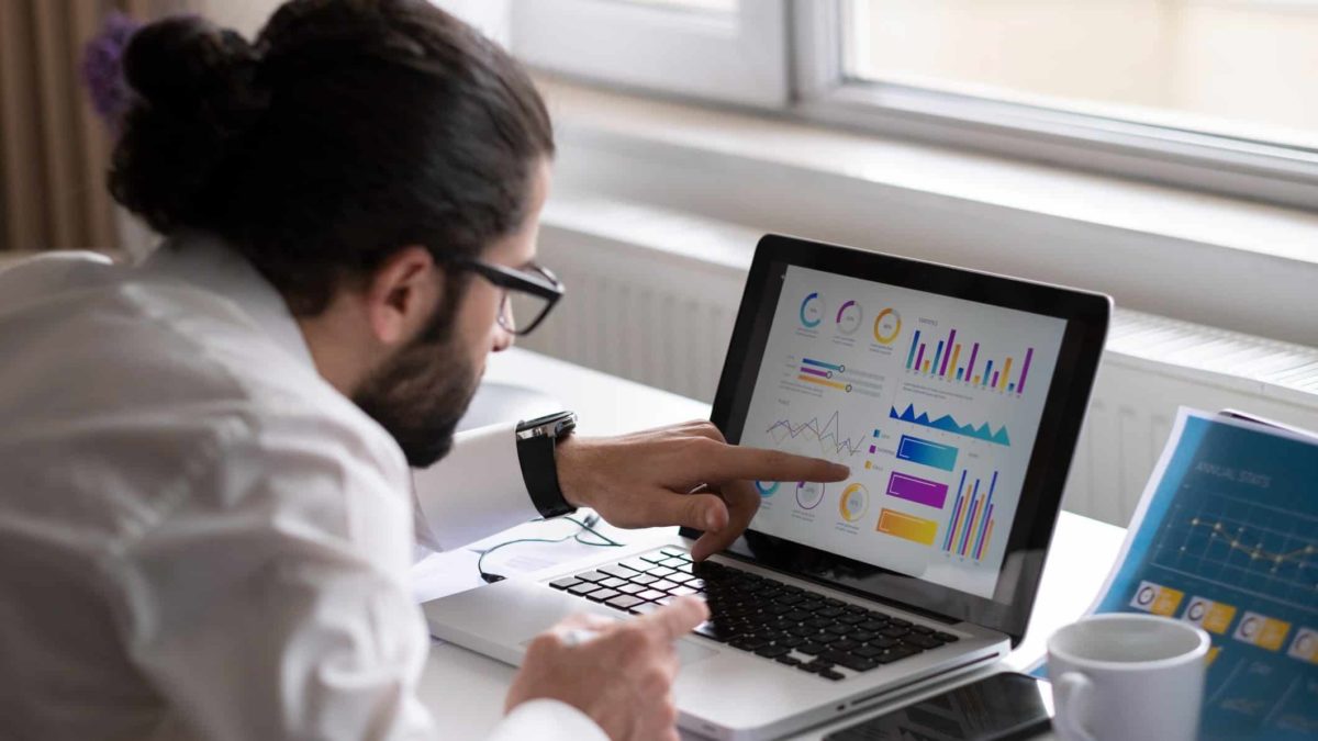 Man on computer looking at graphs