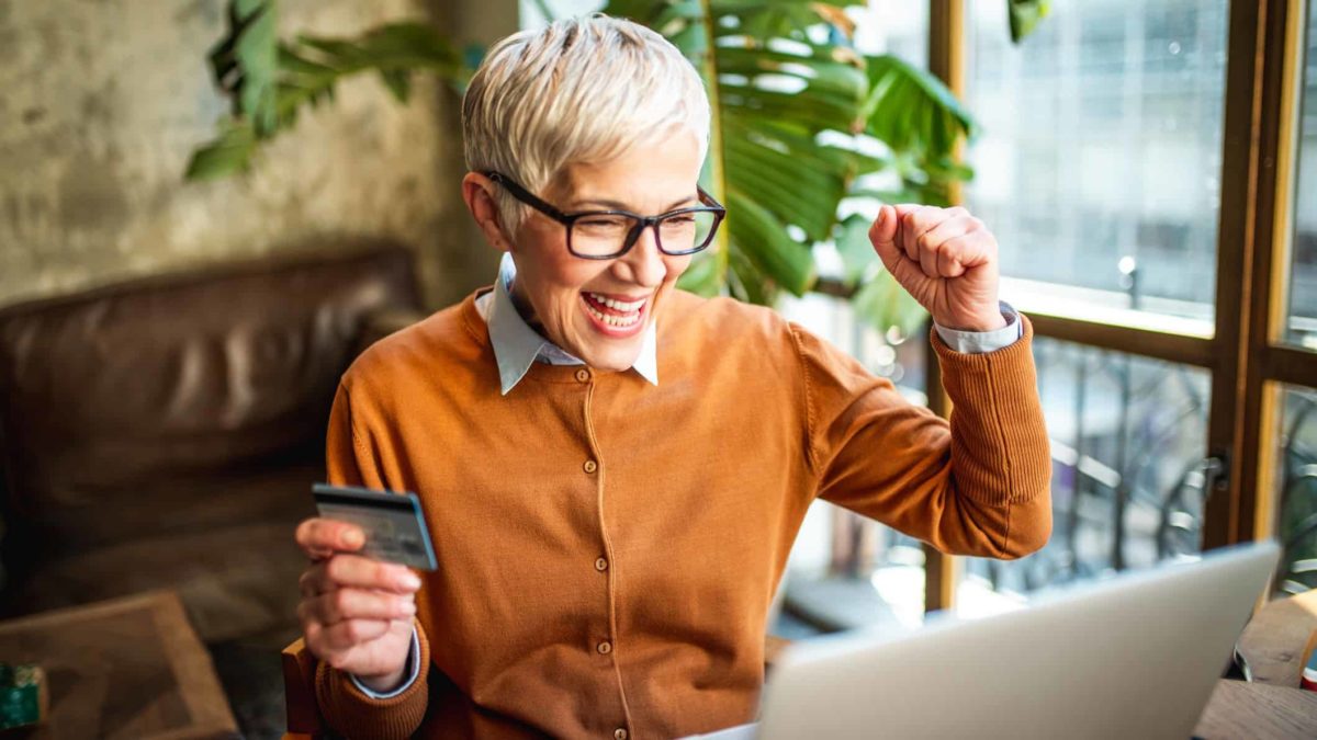 Woman cheers using credit card online