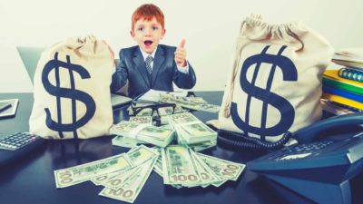 boy giving thumbs up to $100 notes