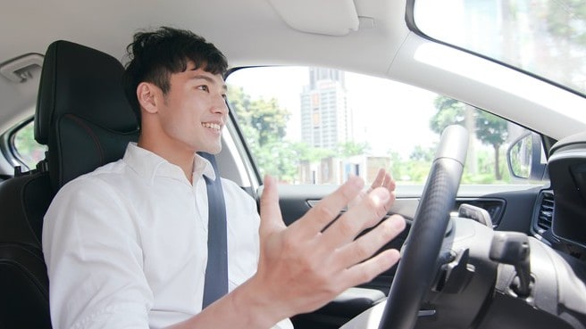 man happy while driving tesla