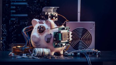 A piggy bank hooked up to mechanical devices, indicating complex financial constructs such as futures trading