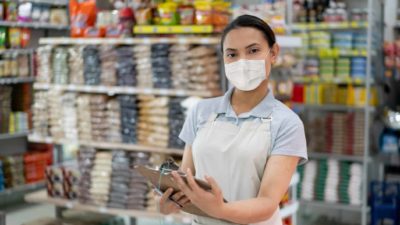 A supermarket worker with a clipboard