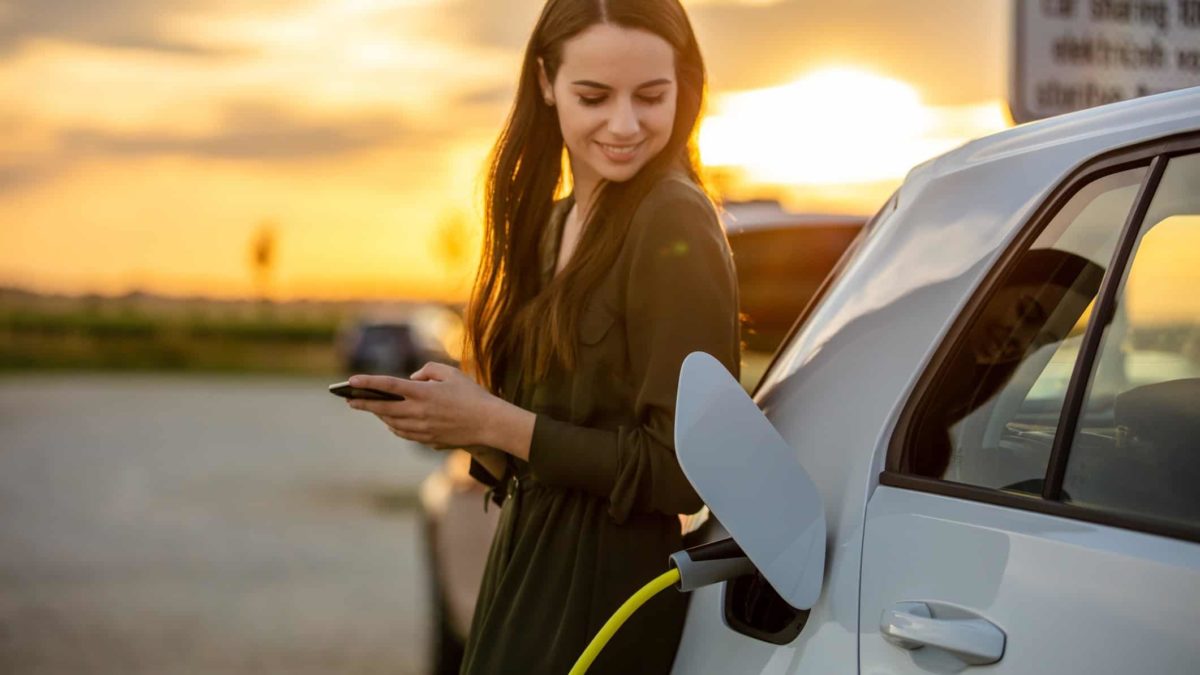 woman happy while charging her Tesla