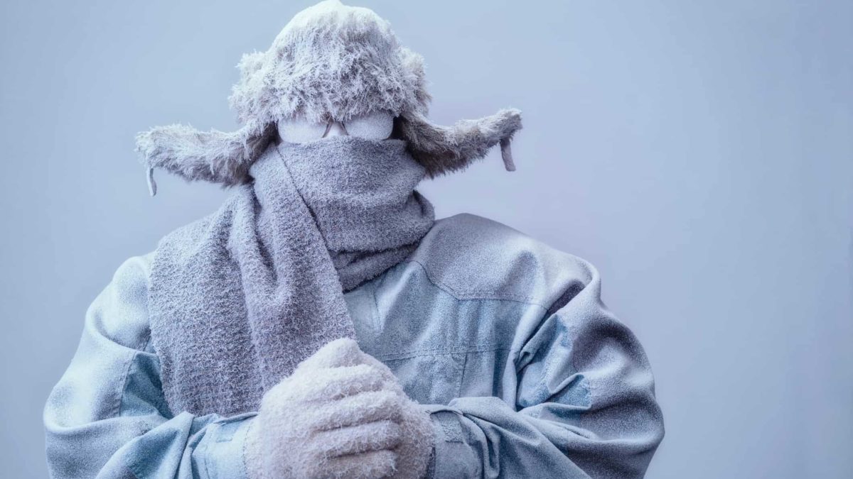 Person covered in snow and freezing