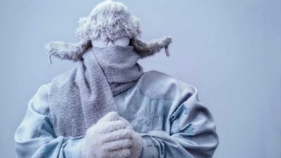 Person covered in snow and freezing