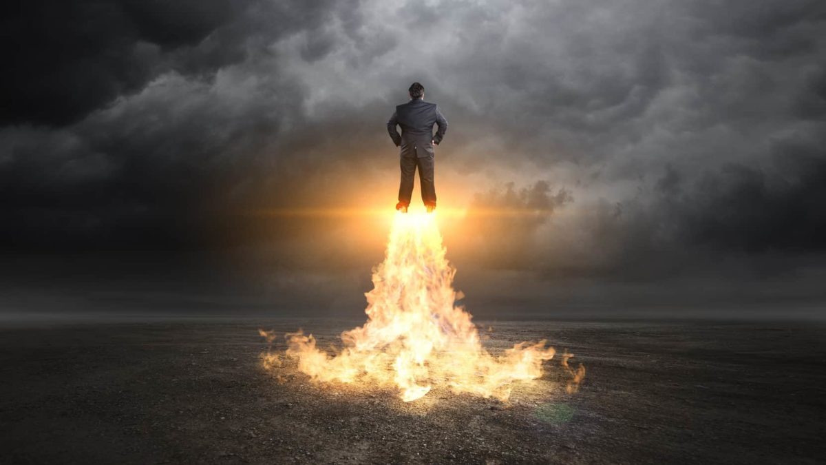 businessman takes off with rockets under feet