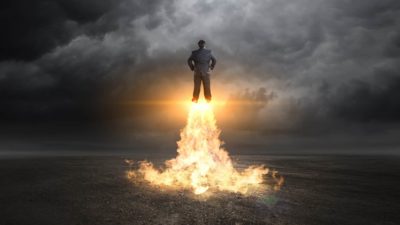 businessman takes off with rockets under feet