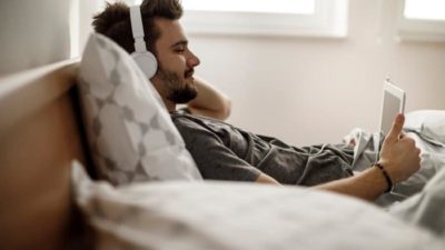 man relaxing and watching netflix