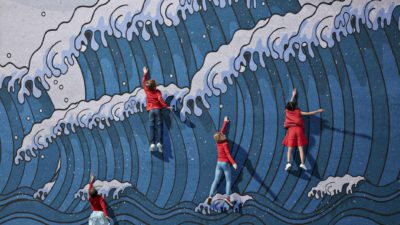 children wearing red clothing are featured on a wall painted with a large wave pattern. The children are standing but are making swimming gestures with their arms to look as though they're battling against the sea.