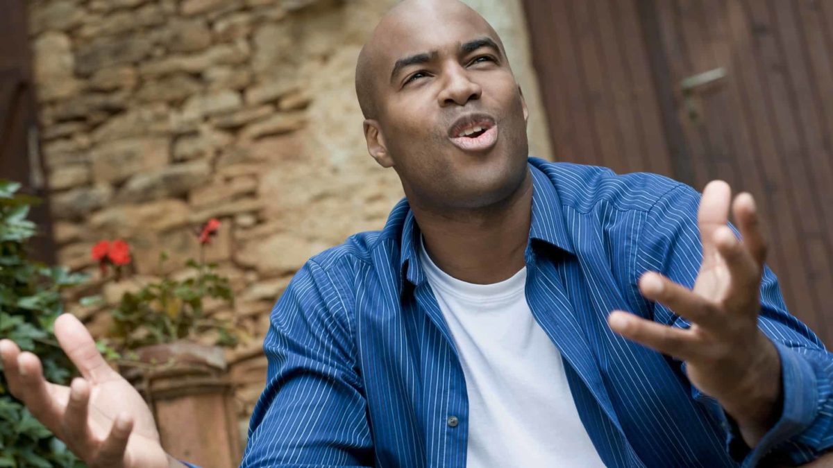 a person with an uncomfortable, questioning expression and arms outstretched as if asking why?