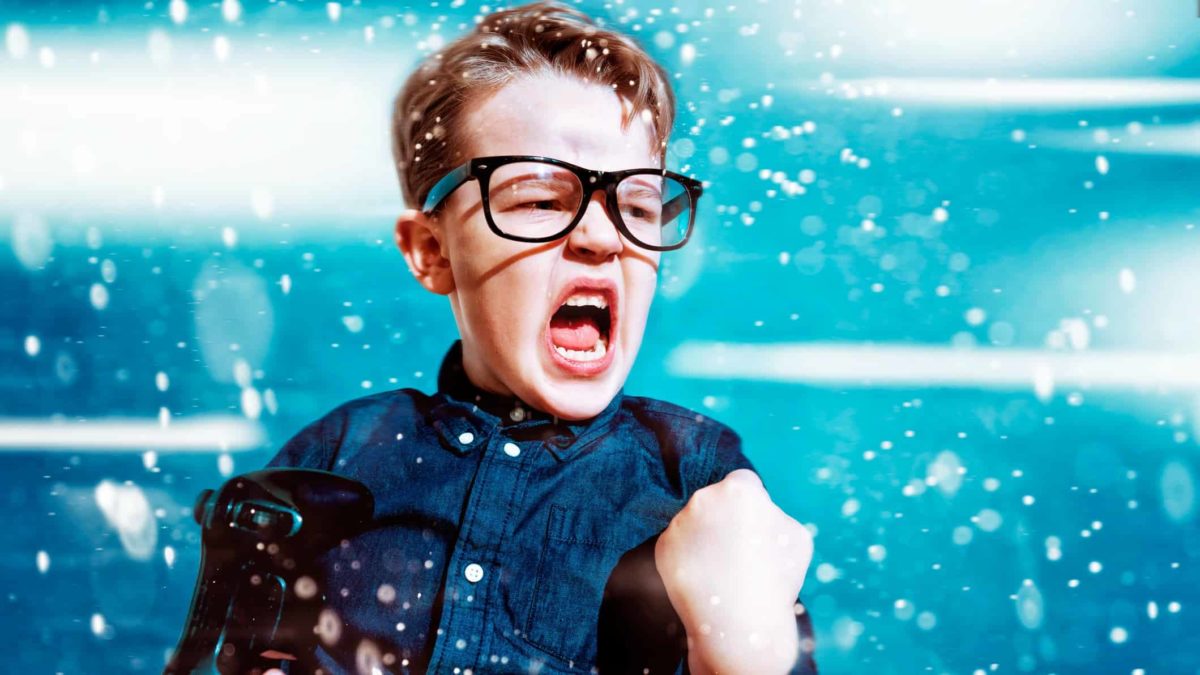 A boy is excited because he won the computer game.