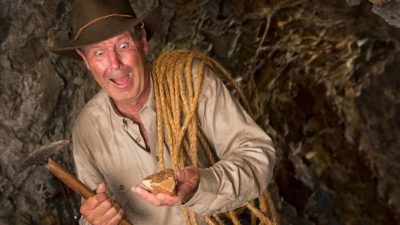 St Barbara share price Minder underground looks excited a he holds a nugget of gold he has discovered.