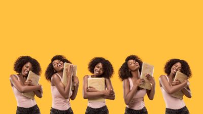 multiple images of a woman hugging and embracing her laptop computer, some with her eyes closed and lips pursed, as though she loves it dearly.