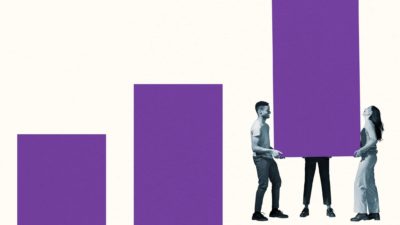 a group of three people carry a large block to line it up in ascending order with two other blocks nearby.