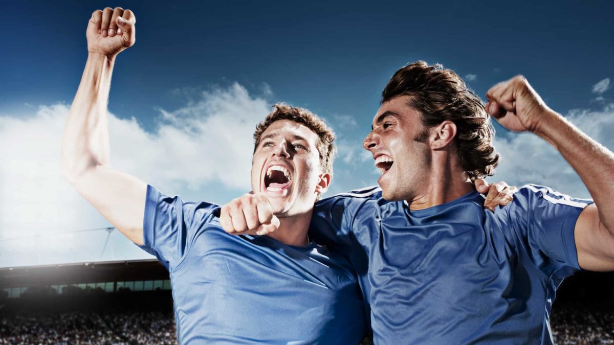 Two players on a field pump their fists in the air, indicating two of the best