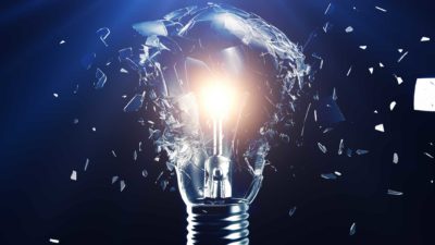 A picture of a lightbulb that is on but the glass is smashing to smithereens, representing the falling Origin share price today