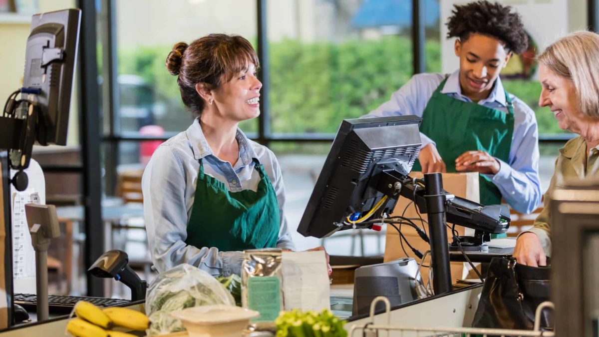 A customer and shopper at the checkout of a supermarket.