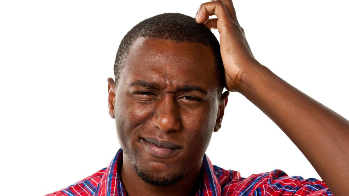 A man with a perplexed expression on his face scratches his head feeling confused about the Hot Chili share price