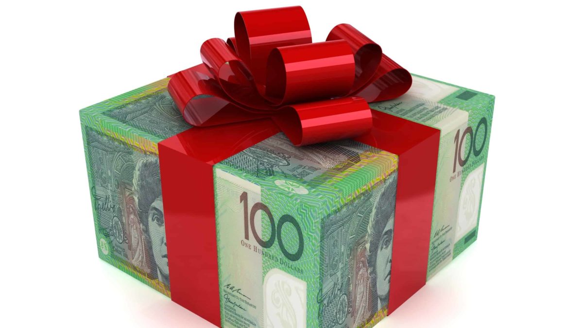 a Christmas present wrapped in one hundred dollar notes and finished with a big red bow