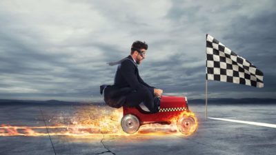 Fast businessman with a car wins against the competitors.