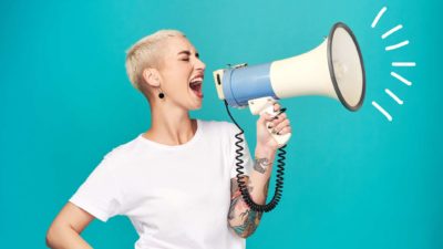 A woman shouts through a megaphone.