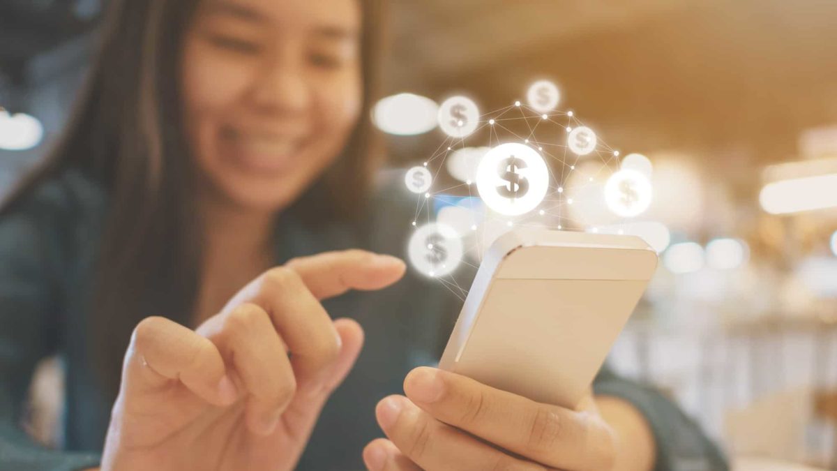 A woman uses her mobile phone to make a purchase.