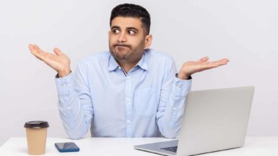 ASX share investor sitting at computer looking confused