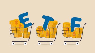 The letters ETF in a trolley with money.