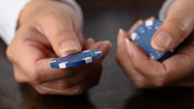 Person holding blue chips.