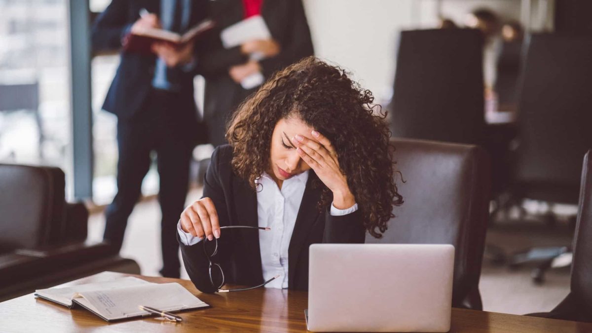 Disappointed woman at the falling share price with her hand oh her had.