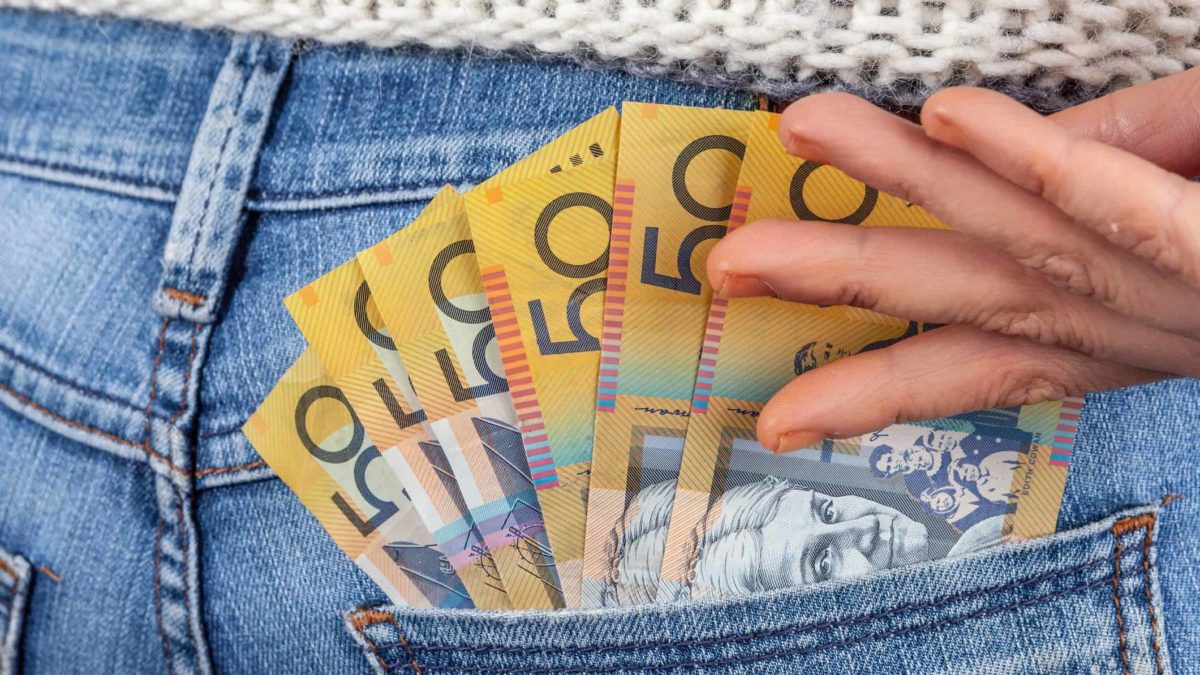 $50 dollar Australian notes in the back pocket of jeans representing dividends.