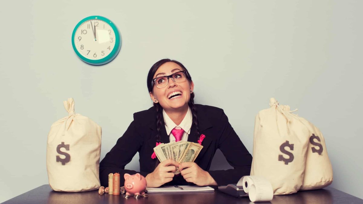 Woman with money on the table and looking upwards.