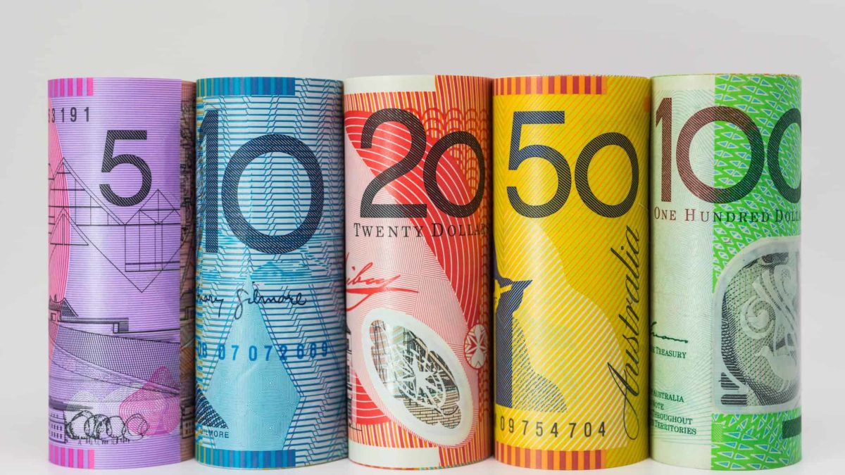 Australian dollar notes rolled into bundles.