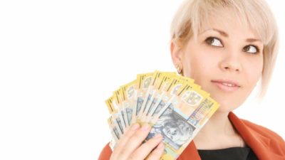 An ASX dividend investor holds a fanned out bunch of $40 Australian cash notes and wonders whether any ASX lithium shares pay dividends