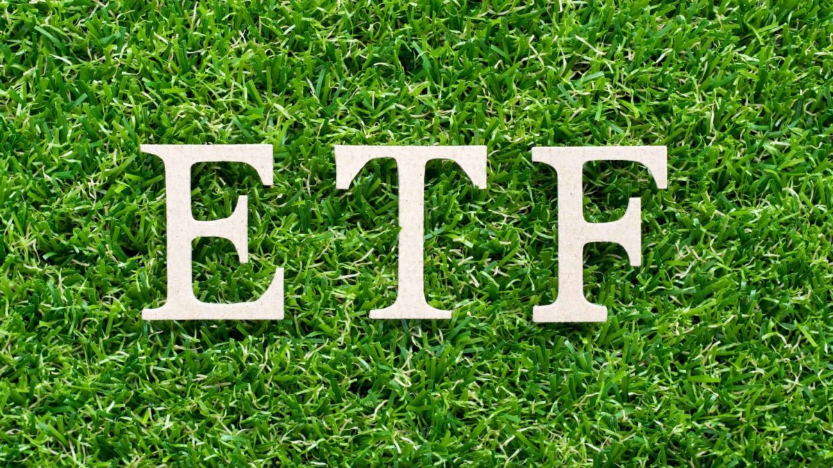 ETF written in white on a grass background.